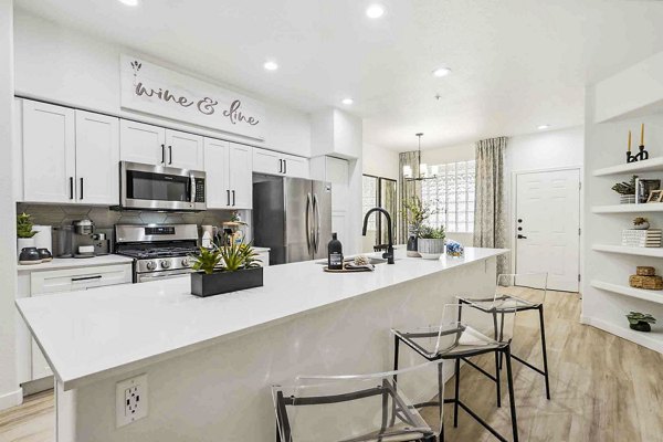Modern kitchen with stainless steel appliances in Zone Luxe Apartments