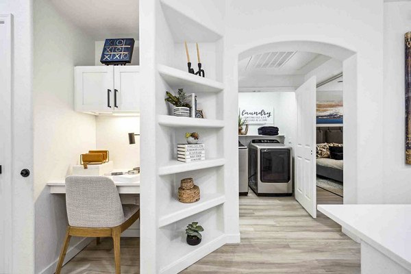 Home office/laundry room with modern decor and efficient storage solutions at Zone Luxe Apartments