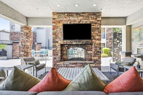 Fire pit on chic patio at Zone Luxe Apartments offering luxury outdoor relaxation