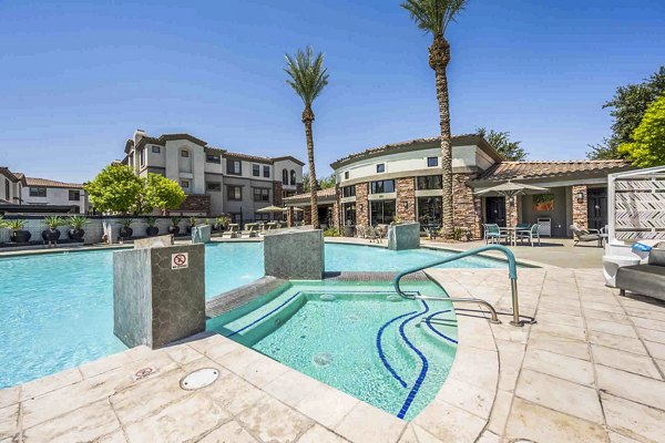 Luxurious pool with sun loungers at Zone Luxe Apartments, offering a relaxing retreat for residents
