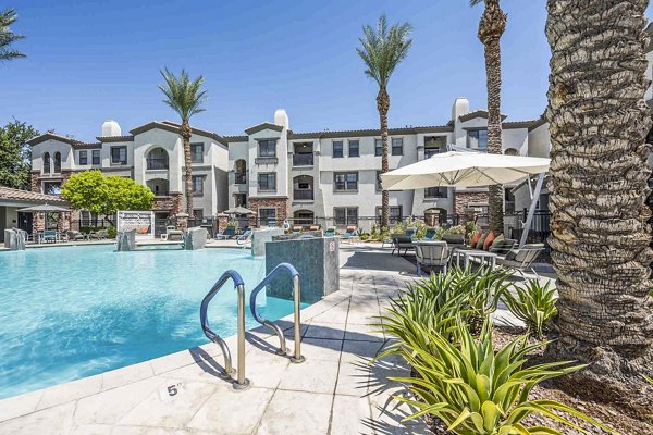 Resort-style pool area at Zone Luxe Apartments with modern lounge seating