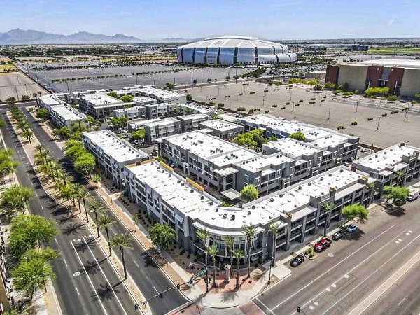 Aerial view of luxury apartments with a large stadium in the background