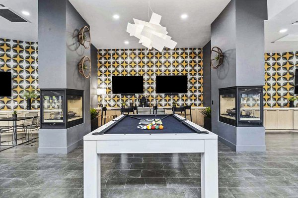 Vibrant game room with billiard table and lounge seating at Zone Westgate Apartments clubhouse