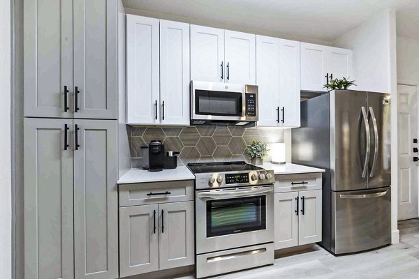Modern kitchen with stainless steel appliances at Zone Westgate Apartments, luxury living