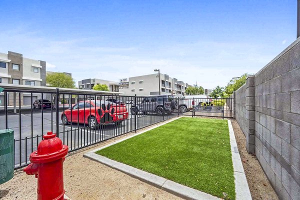 Zone Westgate Apartments: Spacious dog park with modern play equipment and shaded seating areas