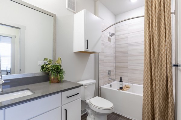 Modern bathroom with sleek fixtures and ample lighting at Five810 Southlands Apartments