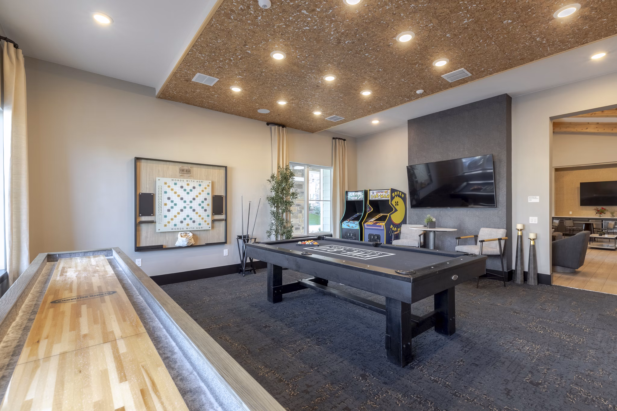 Game room with pool table and lounge seating at Five810 Southlands Apartments