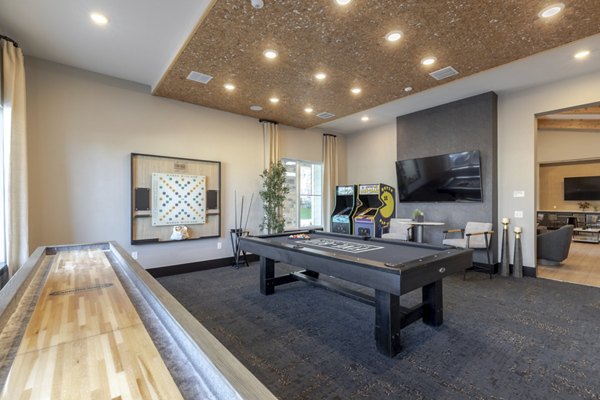 Game room with pool table and lounge seating at Five810 Southlands Apartments