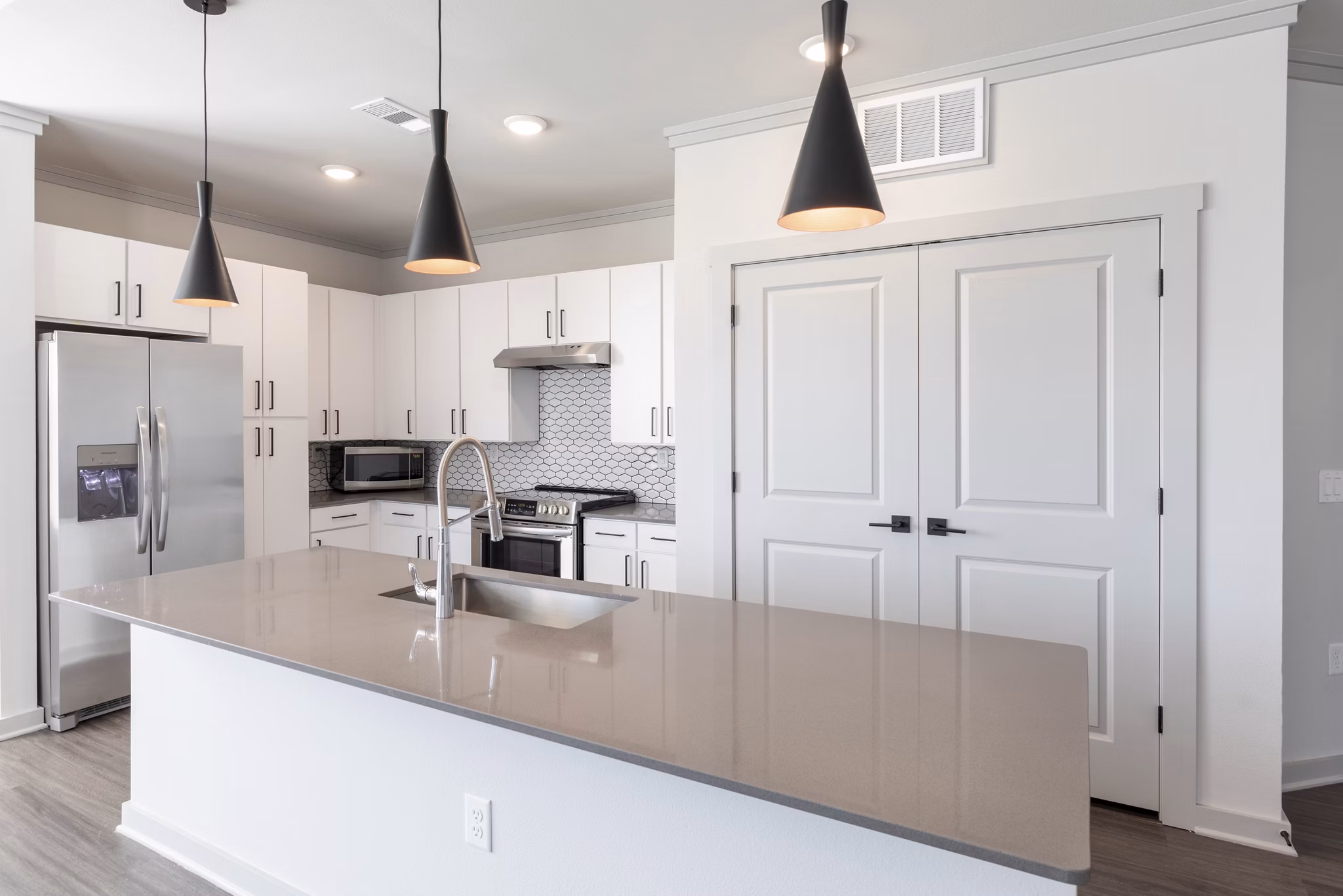 Modern kitchen with stainless steel appliances at Five810 Southlands Apartments
