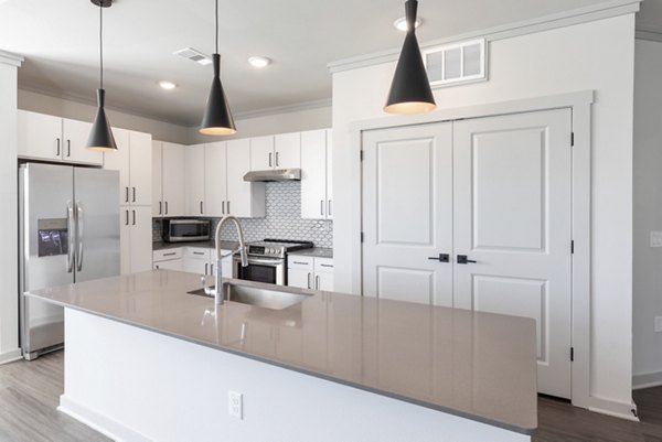 Modern kitchen with stainless steel appliances at Five810 Southlands Apartments