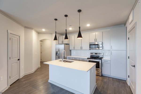 Modern kitchen with sleek countertops and stainless steel appliances at Five810 Southlands Apartments, a Greystar luxury community