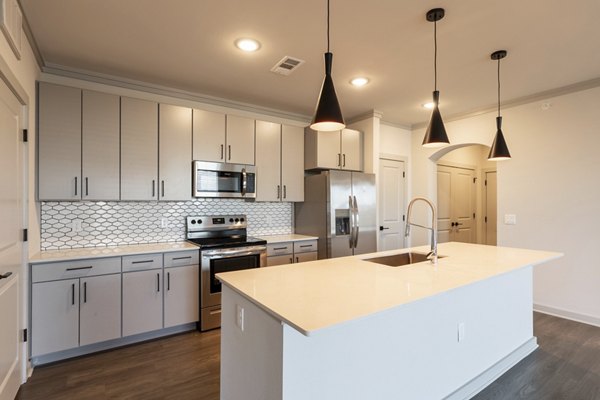 Modern kitchen with stainless steel appliances at Five810 Southlands Apartments