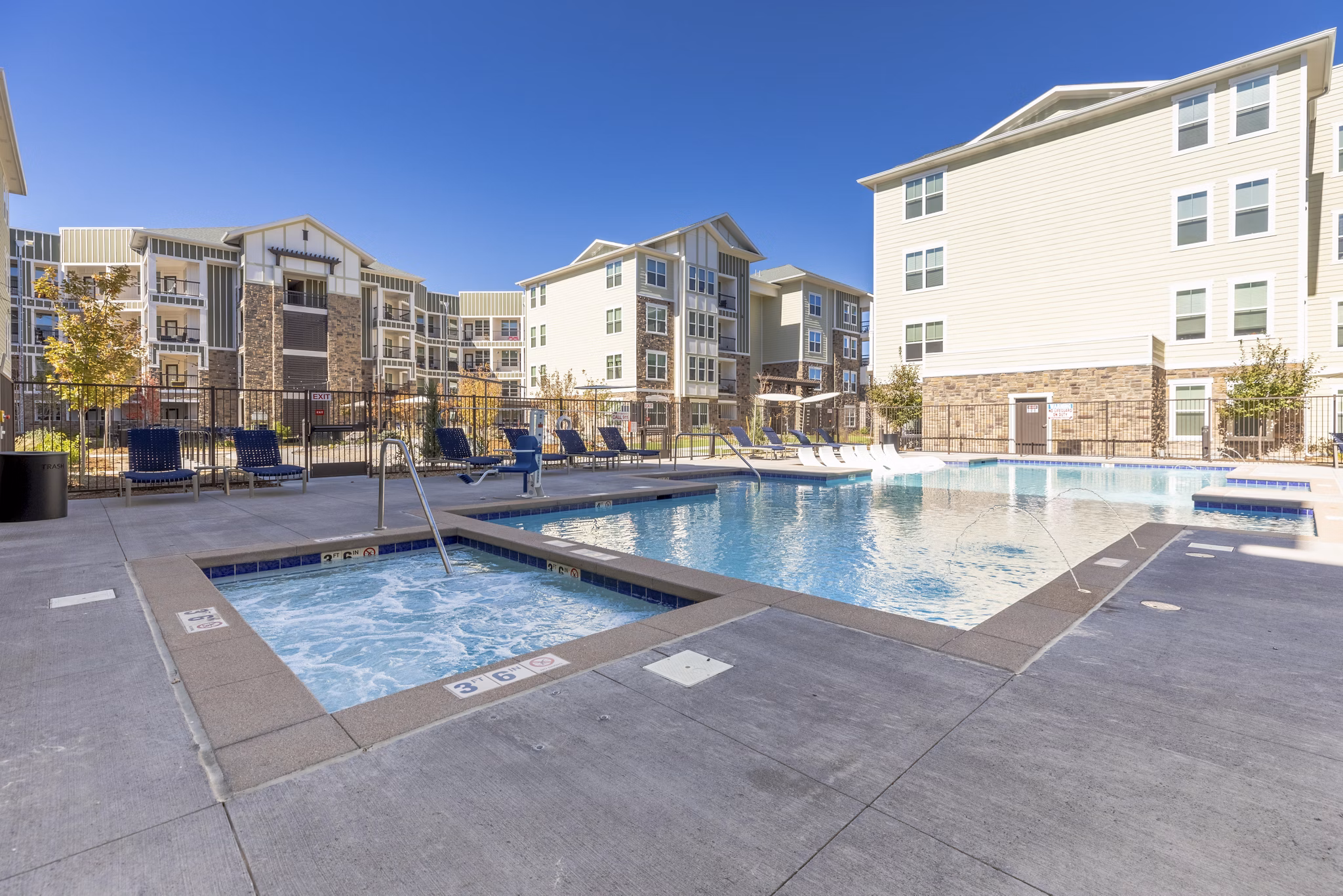 Resort-style pool surrounded by lush greenery at Five810 Southlands Apartments, perfect for relaxation and leisure activities