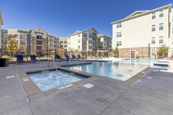Resort-style pool surrounded by lush greenery at Five810 Southlands Apartments, perfect for relaxation and leisure activities
