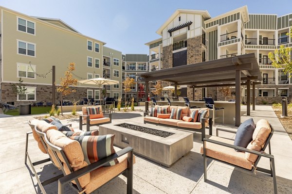 Cozy outdoor fire pit area with seating at Five810 Southlands Apartments