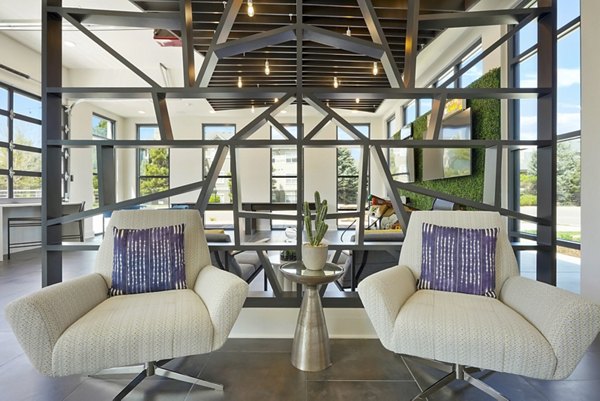 Clubhouse featuring modern design and comfy seating at Mezz at Fiddler's Green Apartments