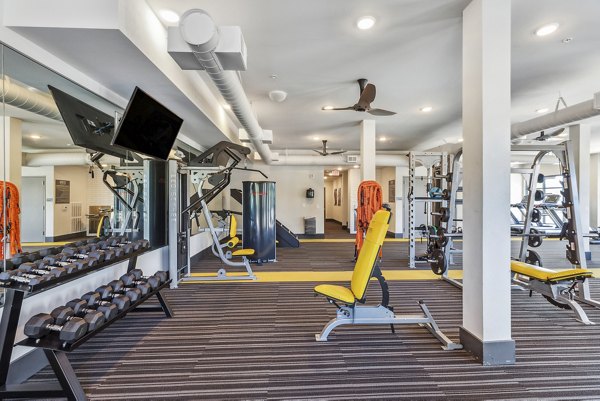 State-of-the-art fitness center at Mezz at Fiddler's Green Apartments with modern equipment and spacious workout areas