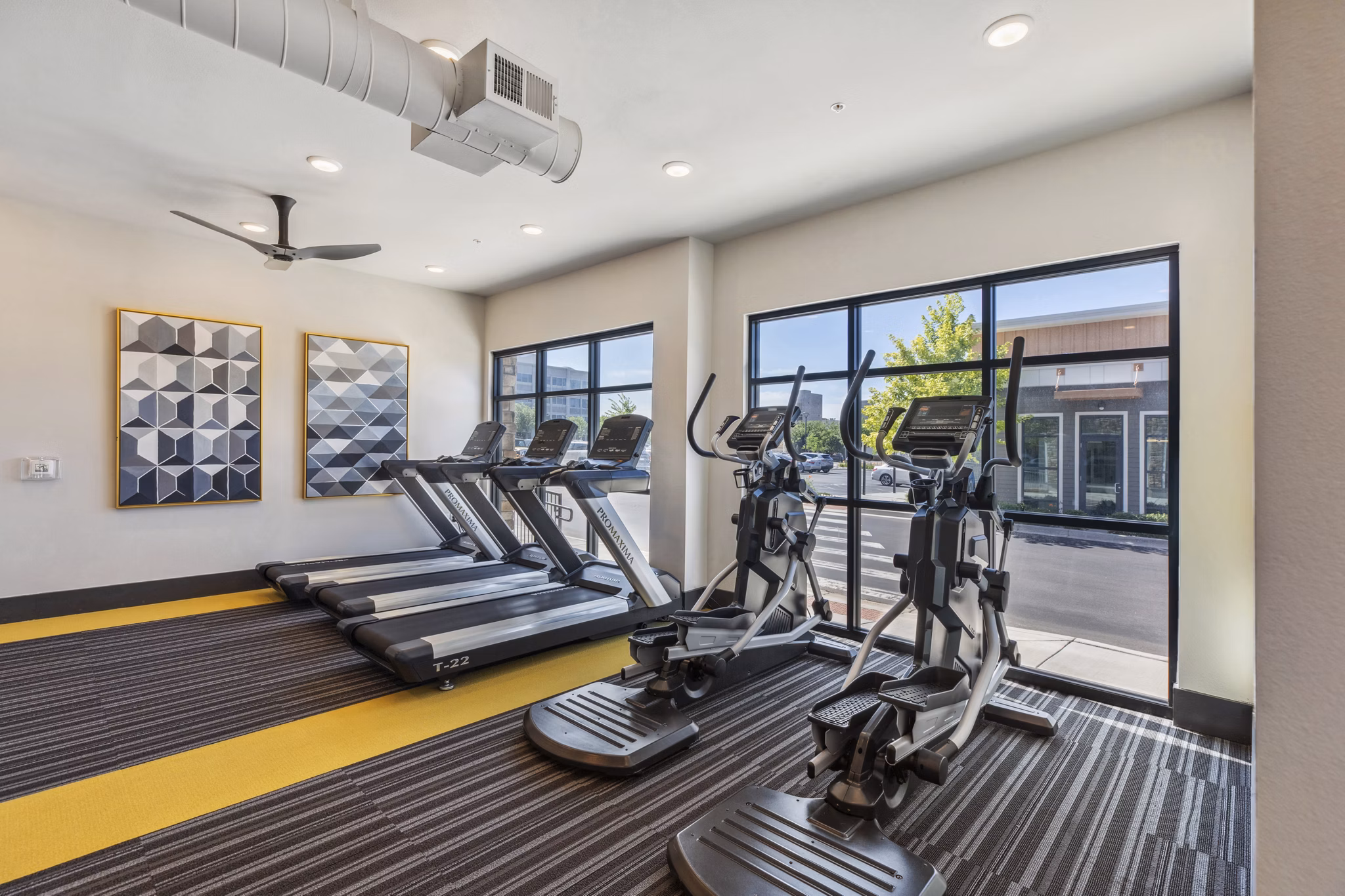 Modern fitness center with state-of-the-art equipment at Mezz at Fiddler's Green Apartments