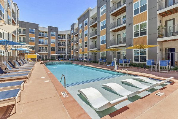 Resort-style pool area at Mezz at Fiddler's Green Apartments, offering luxury outdoor relaxation in a stylish setting