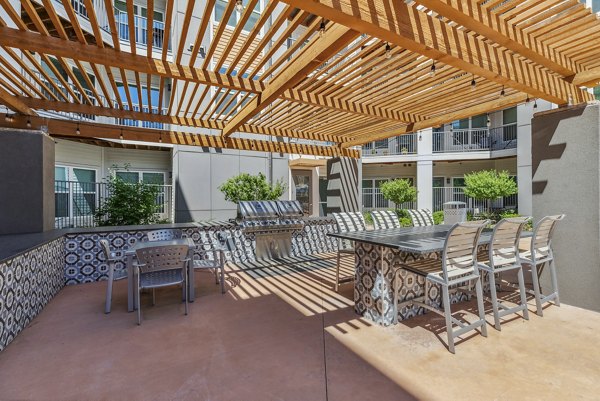 Outdoor patio with stylish seating at Mezz at Fiddler's Green Apartments ideal for social gatherings