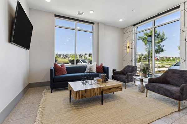 Modern clubhouse with lounge seating at Talus Flats Apartments, offering luxury amenities and social spaces for residents