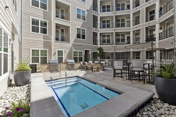 Resort-style swimming pool with lounge chairs at Talus Flats Apartments