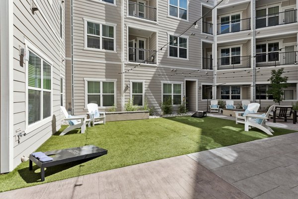 Tranquil courtyard with lush greenery and seating at Talus Flats Apartments, a premier Greystar luxury community