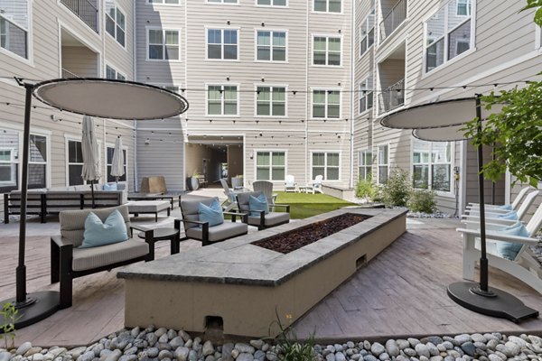 Cozy fire pit seating area at Talus Flats Apartments, perfect for outdoor gatherings and relaxation