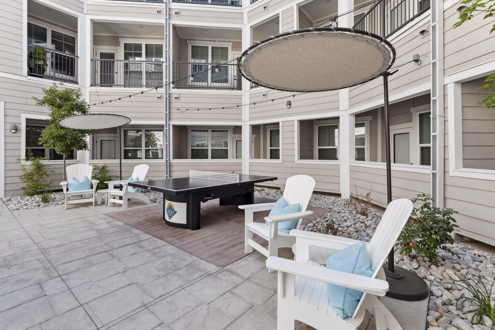 Serene courtyard at Talus Flats Apartments featuring lush landscaping and seating areas