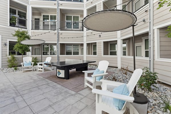 Serene courtyard at Talus Flats Apartments featuring lush landscaping and seating areas