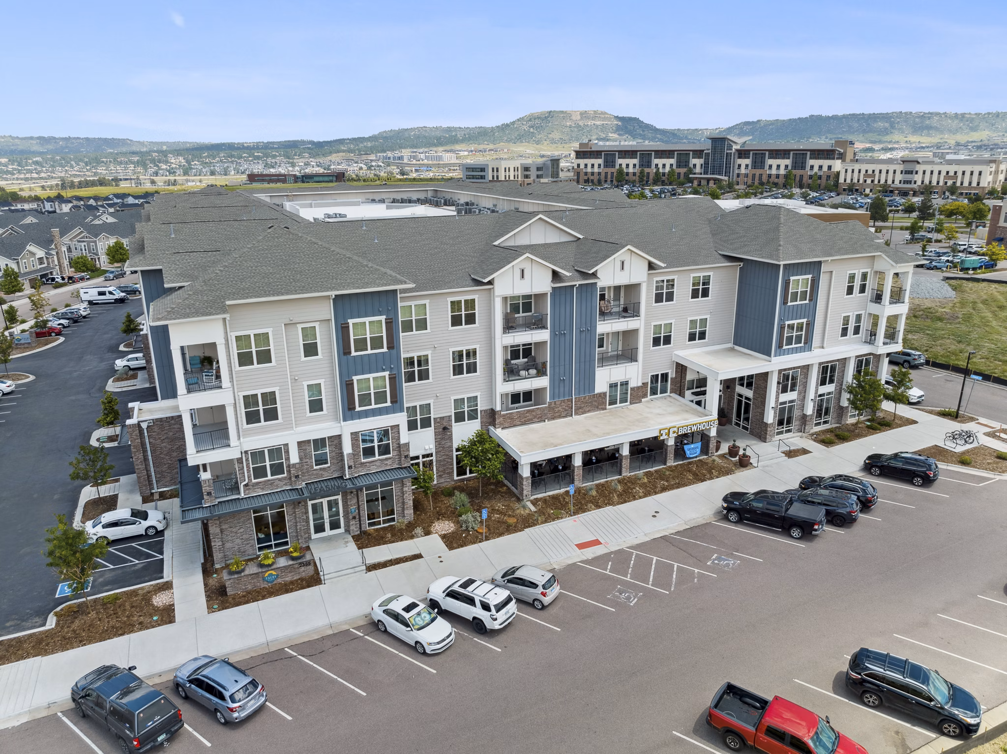 Panoramic view of Talus Flats luxury apartments surrounded by lush greenery in Greystar community