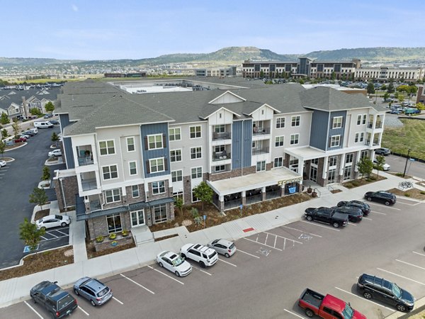 Panoramic view of Talus Flats luxury apartments surrounded by lush greenery in Greystar community