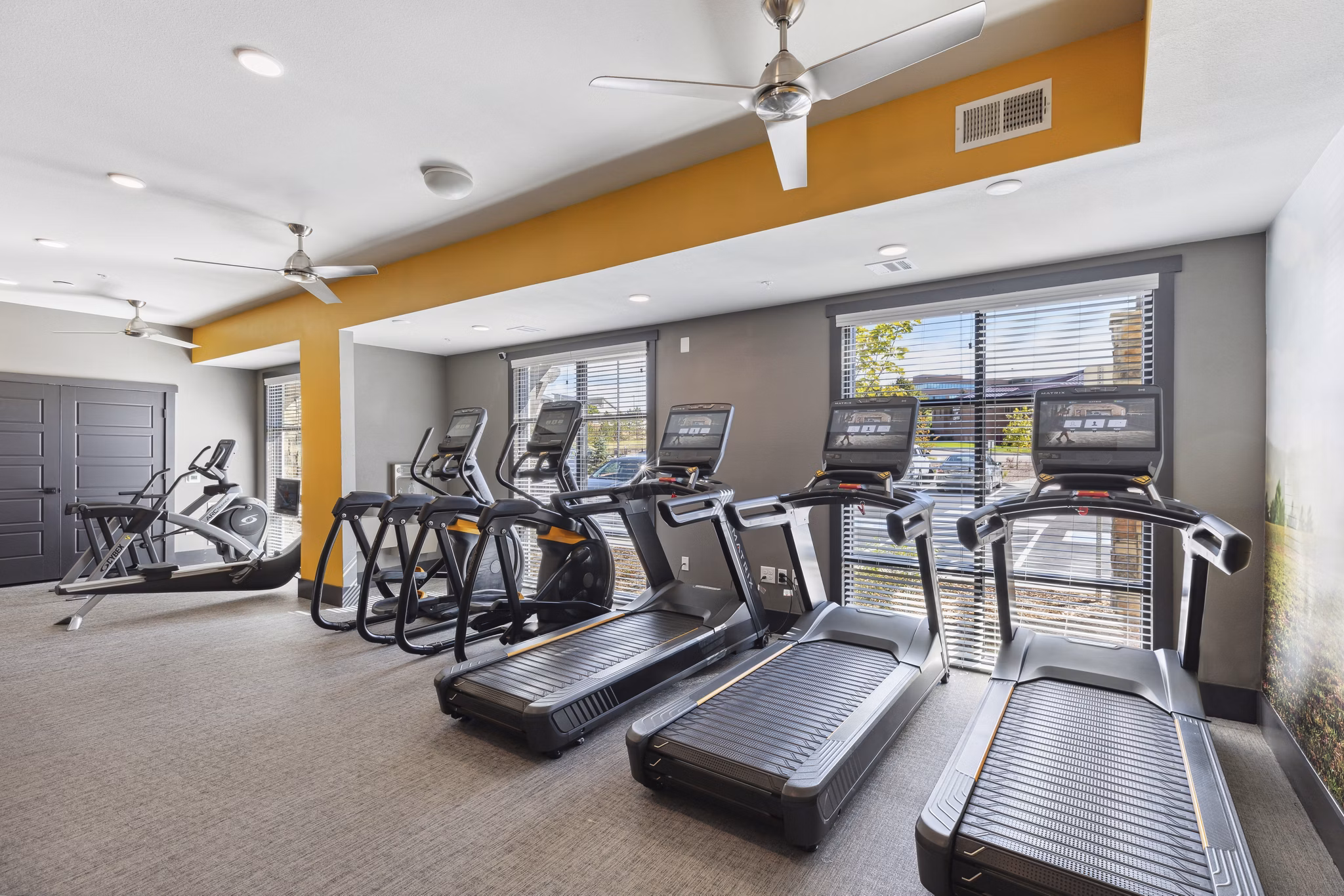 State-of-the-art fitness center at The Zeb Apartments with modern equipment and spacious workout area