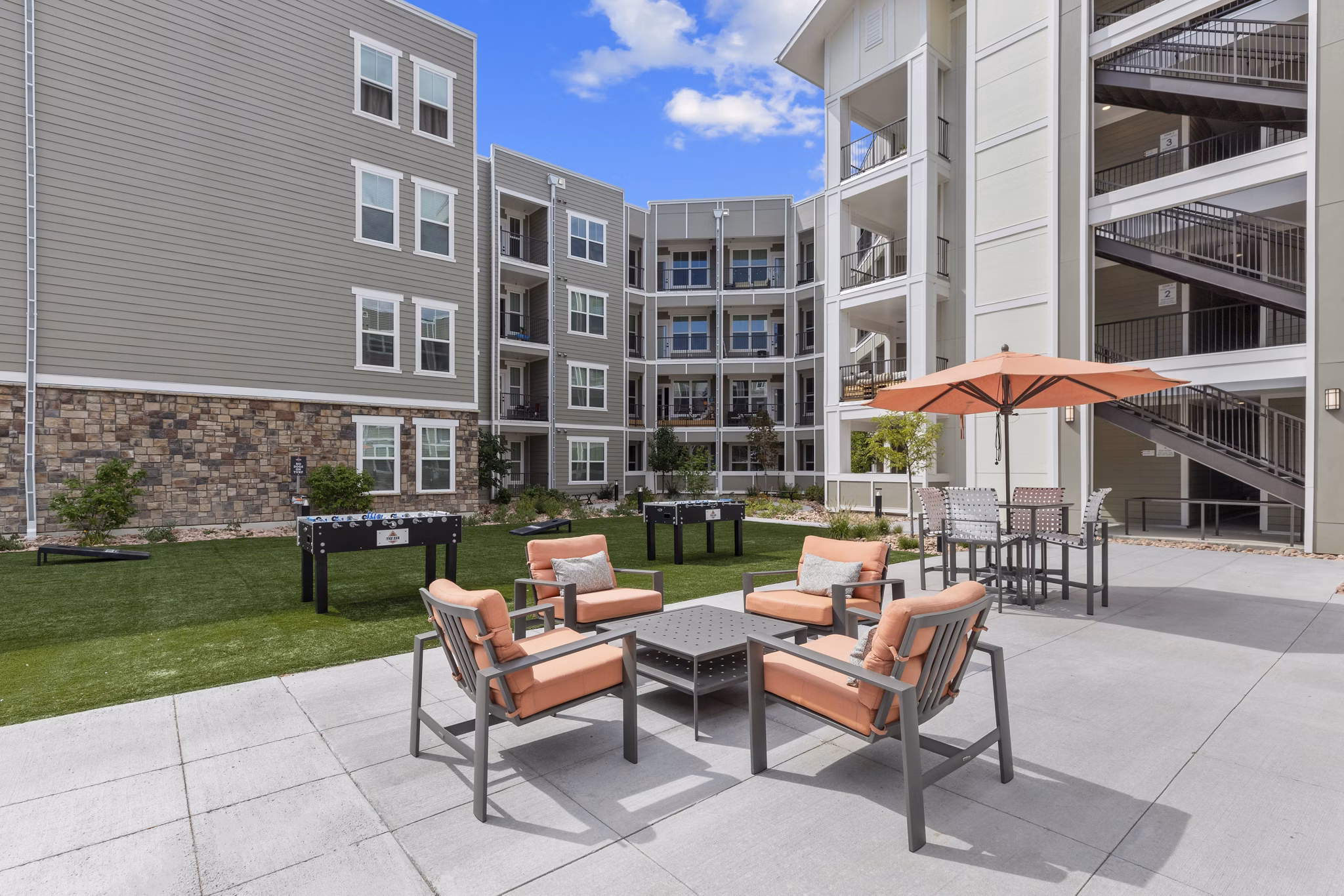 Courtyard featuring modern seating and lush landscaping at The Zeb Apartments, offering luxury living in a Greystar community