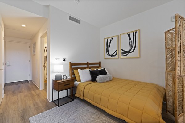 Cozy bedroom with modern furnishings at The Clark Apartments