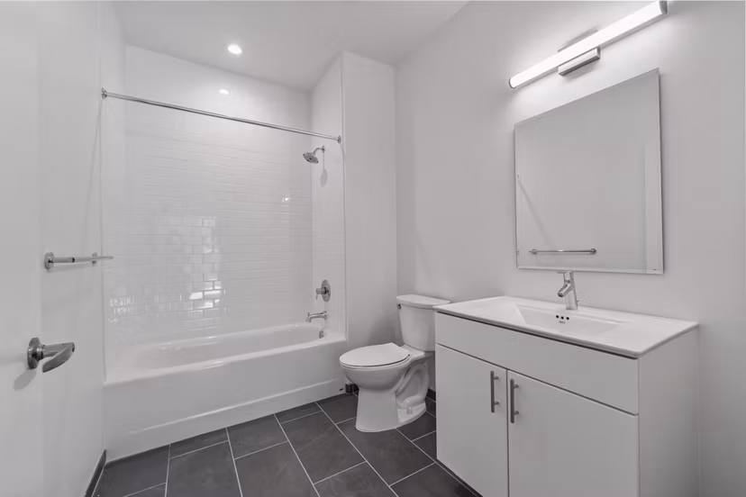 Luxurious bathroom with sleek fixtures and spacious layout at The Clark Apartments