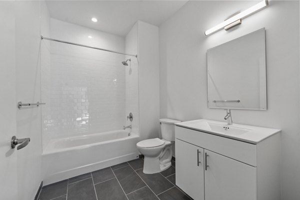 Luxurious bathroom with sleek fixtures and spacious layout at The Clark Apartments