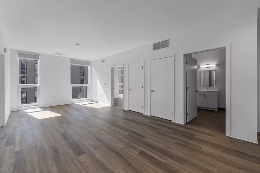 Spacious kitchen with modern appliances and island seating at The Clark Apartments