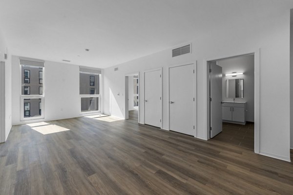 Spacious kitchen with modern appliances and island seating at The Clark Apartments