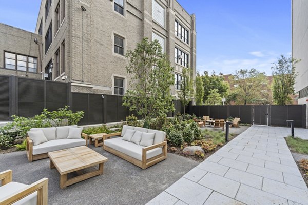 Serene courtyard with lush landscaping at The Clark Apartments, a Greystar luxury property