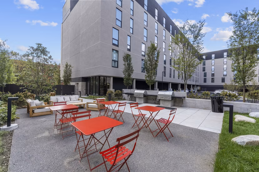 Modern outdoor grill area at The Clark Apartments, luxury living offered by Greystar in a vibrant community setting