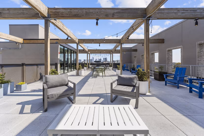 Rooftop deck with lounge seating and city views at The Clark Apartments