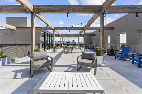 Rooftop deck with lounge seating and city views at The Clark Apartments