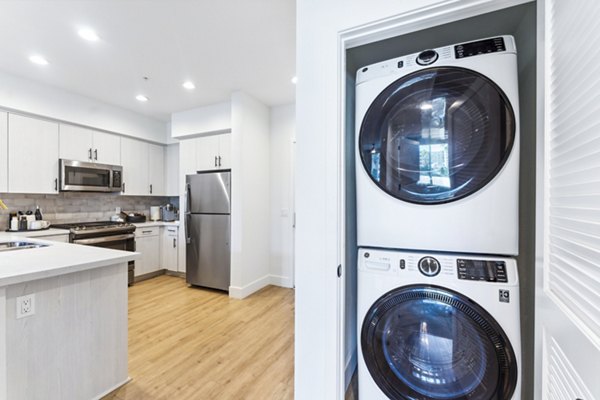 kitchen and laundry machine at Vive Luxe Apartments
