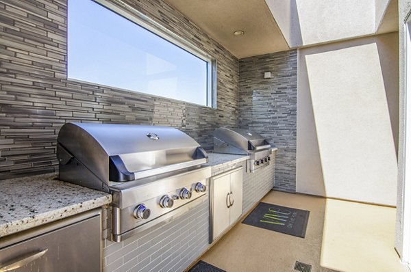 grill area/patio at Vive on the Park Apartments
