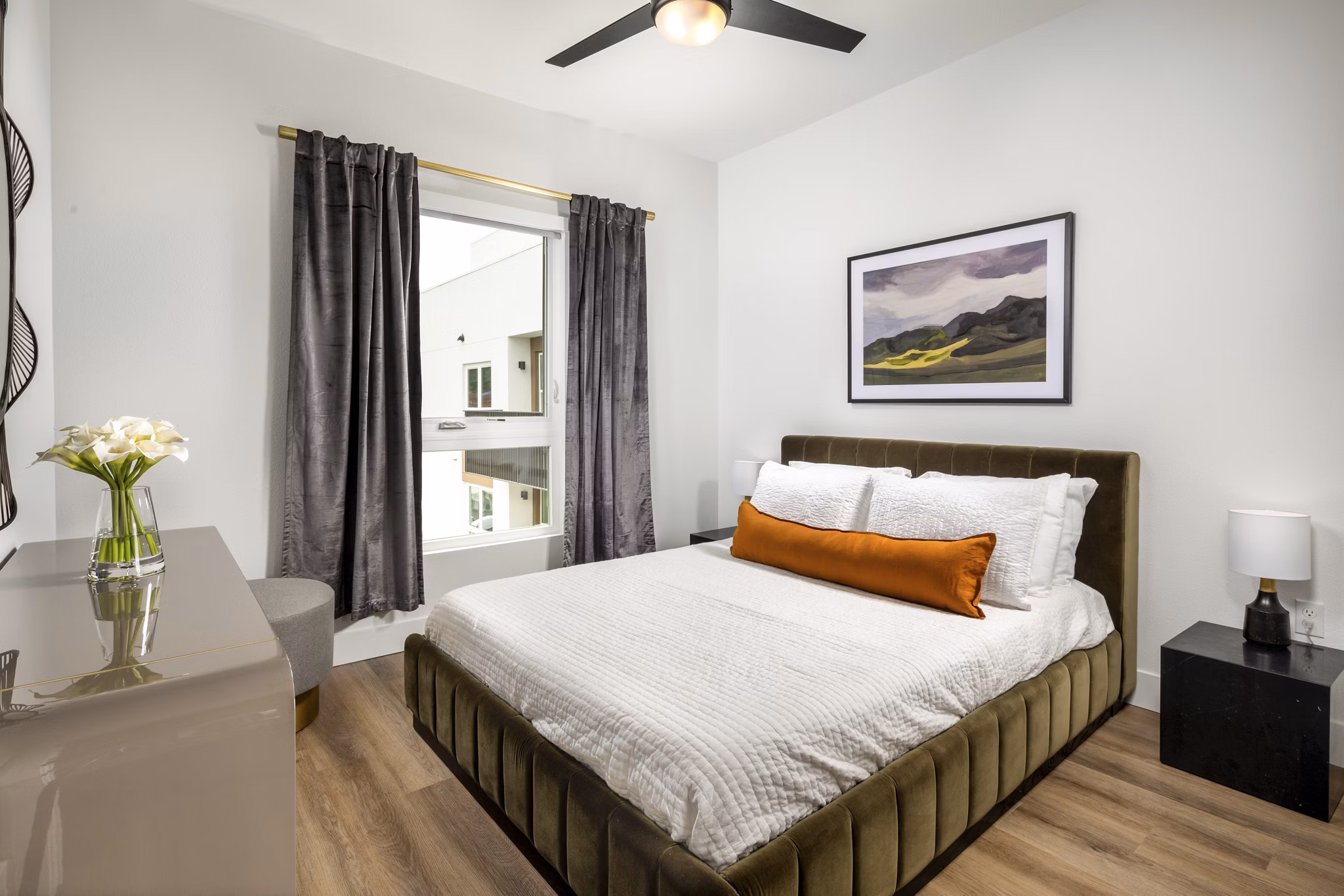 Cozy bedroom with modern decor at Vora Lux Apartments in Greystar community