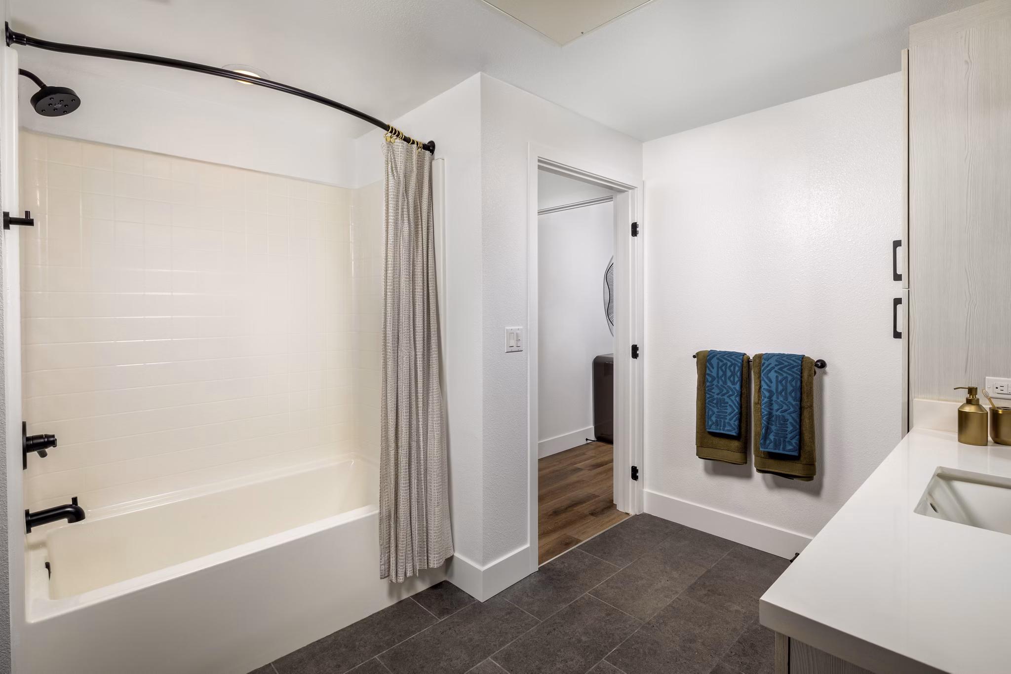 Bathroom with modern fixtures and marble countertops at Vora Lux Apartments, a luxury community by Greystar