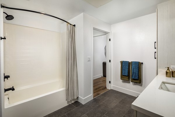 Bathroom with modern fixtures and marble countertops at Vora Lux Apartments, a luxury community by Greystar