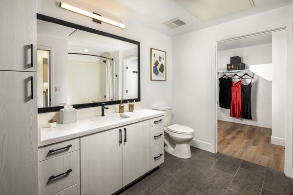 Modern bathroom with marble countertops and spacious shower in Vora Lux Apartments