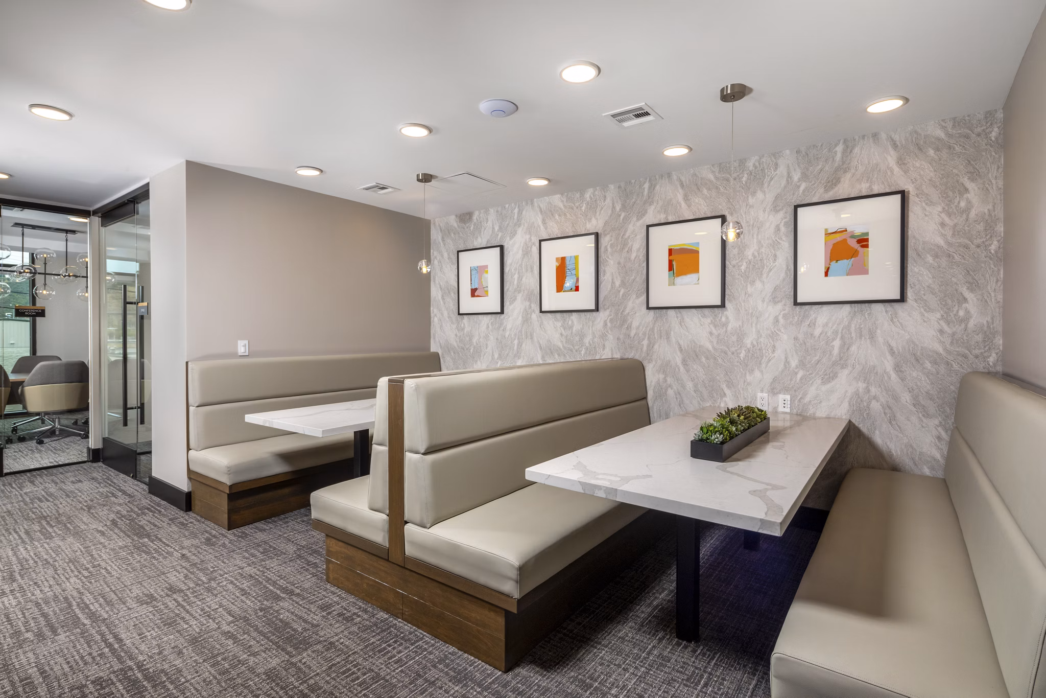 Clubhouse with modern design and seating areas at Vora Lux Apartments, a luxury Greystar property